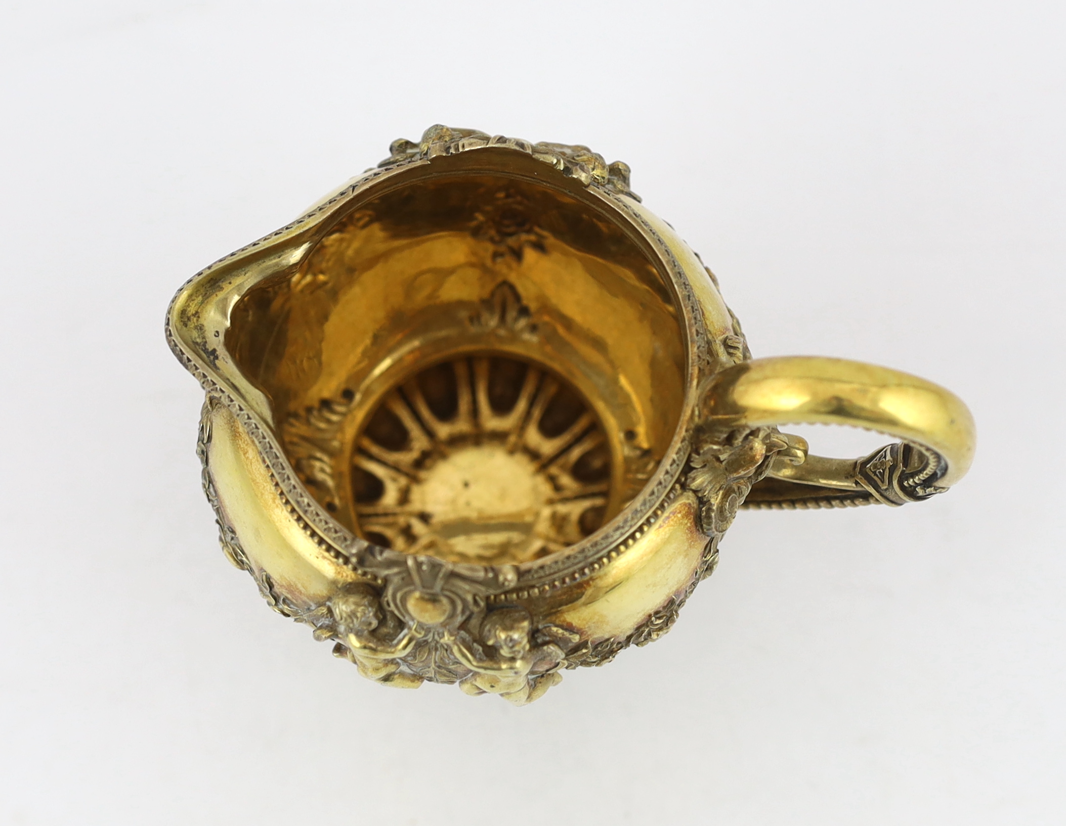 An early Victorian ornate silver gilt cream jug, by George Ivory